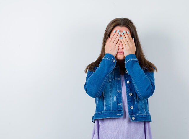 young-woman-keeping-hands-eyes-t-shirt-jacket-looking-scared-front-view_176474-108233