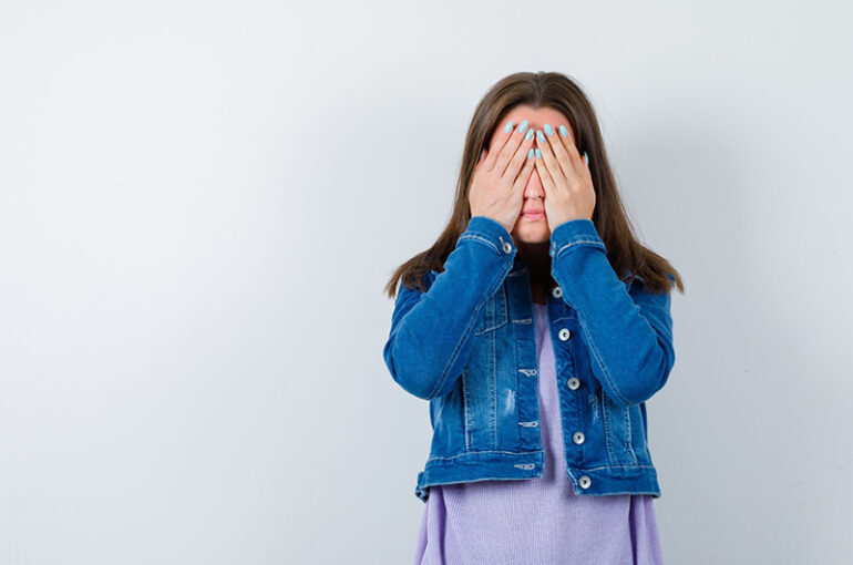 young-woman-keeping-hands-eyes-t-shirt-jacket-looking-scared-front-view_176474-108233